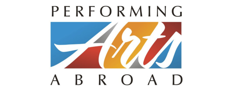 Black female actor in jacket and glasses looking up in to stage light