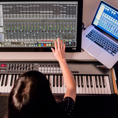 Full Sail's Project Launchbox where a student is working with a mixing console and a Macbook